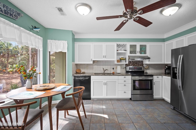 kitchen with decorative backsplash, white cabinetry, stainless steel appliances, and a sink