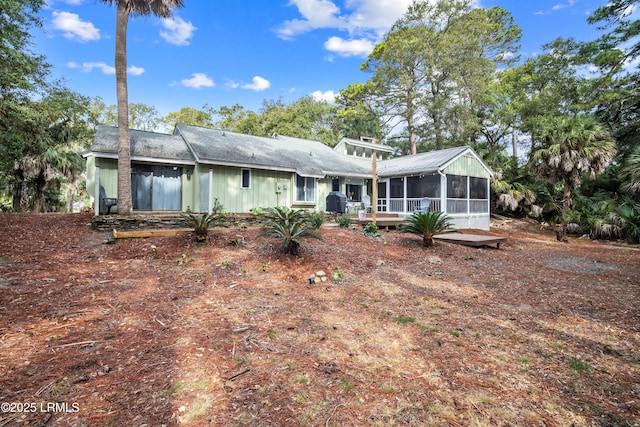 rear view of property with a sunroom