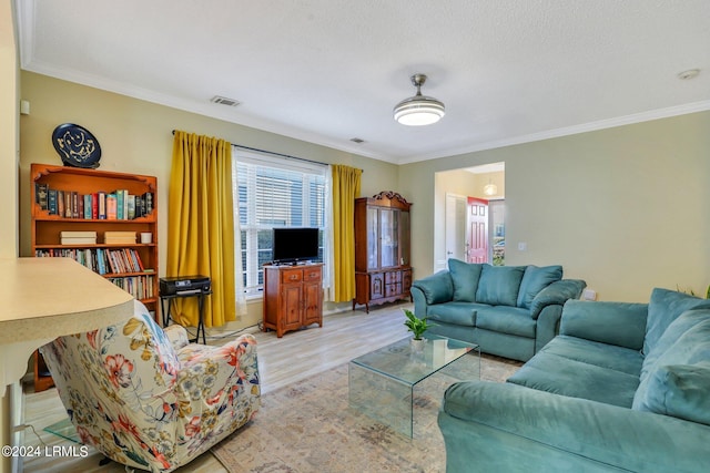 living room featuring light hardwood / wood-style flooring and ornamental molding