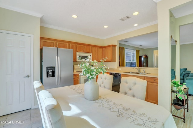 kitchen with white appliances, ornamental molding, kitchen peninsula, and sink