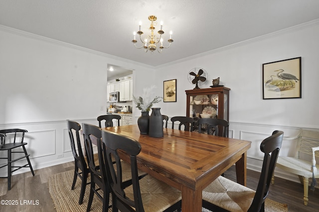 249 Hitching Post Cres, Bluffton, SC 29910 - dining room with ornamental molding, a chandelier, dark wood finished floors, a wainscoted wall, and a decorative wall