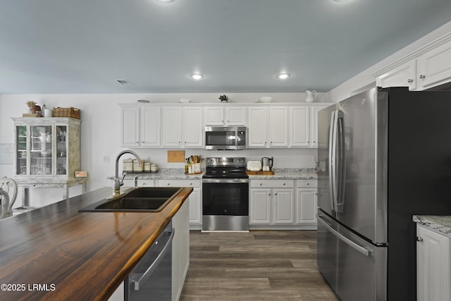 249 Hitching Post Cres, Bluffton, SC 29910 - kitchen featuring stainless steel appliances, a sink, wooden counters, white cabinets, and recessed lighting