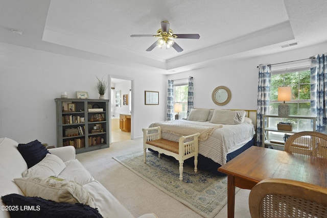 249 Hitching Post Cres, Bluffton, SC 29910 - bedroom featuring a raised ceiling, light carpet, ensuite bath, and ceiling fan