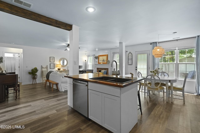 249 Hitching Post Cres, Bluffton, SC 29910 - kitchen featuring a sink, dishwasher, open floor plan, a fireplace, and an island with sink