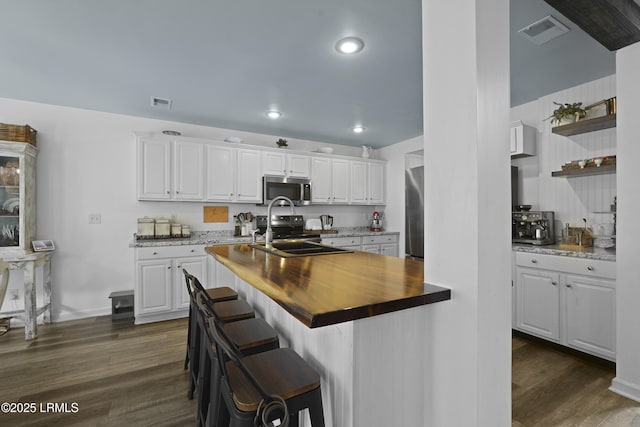 249 Hitching Post Cres, Bluffton, SC 29910 - kitchen featuring butcher block countertops, stainless steel appliances, dark wood-style flooring, white cabinetry, and recessed lighting