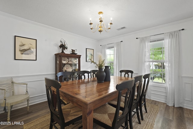 249 Hitching Post Cres, Bluffton, SC 29910 - dining area featuring a chandelier, wood finished floors, crown molding, a wainscoted wall, and plenty of natural light