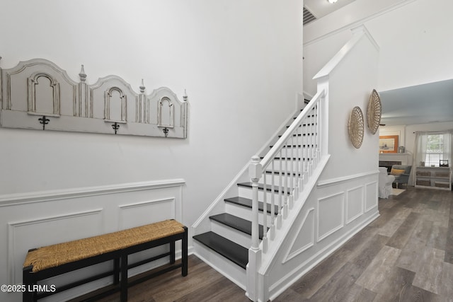 249 Hitching Post Cres, Bluffton, SC 29910 - stairway with a decorative wall, wainscoting, wood finished floors, and a fireplace