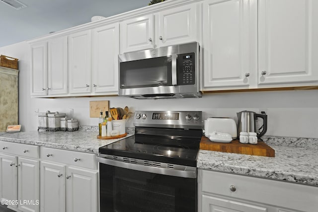 249 Hitching Post Cres, Bluffton, SC 29910 - kitchen featuring stainless steel appliances, white cabinets, and light stone countertops