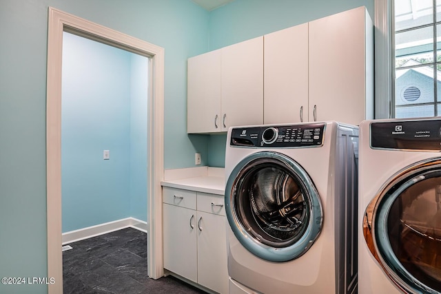 washroom featuring cabinets and separate washer and dryer