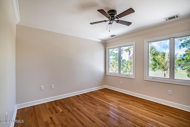 empty room featuring crown molding, ceiling fan, and hardwood / wood-style floors