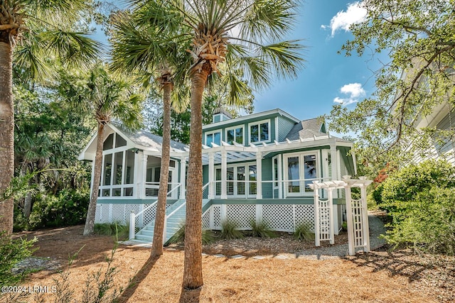 rear view of house featuring a pergola