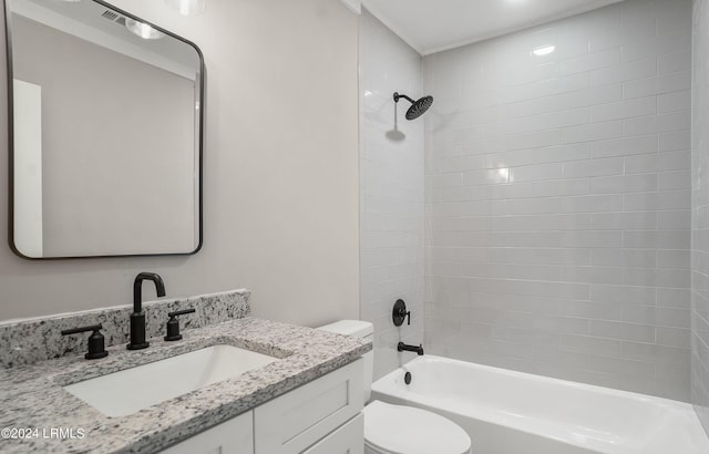 full bathroom with vanity, toilet, and tiled shower / bath