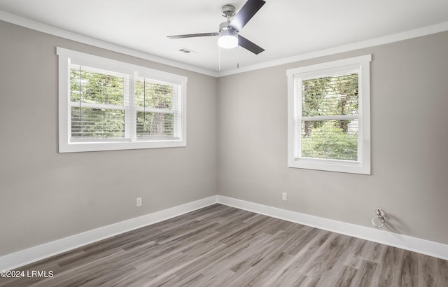 empty room with hardwood / wood-style flooring, ceiling fan, and ornamental molding