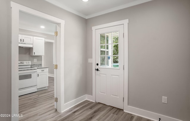 doorway featuring crown molding and light wood-type flooring