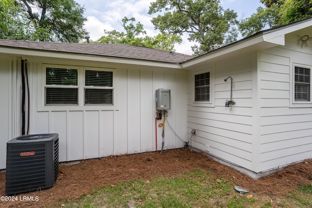 view of side of property with central air condition unit