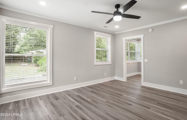 spare room featuring dark hardwood / wood-style flooring, crown molding, and ceiling fan