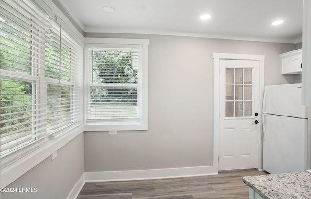 interior space featuring crown molding and hardwood / wood-style floors