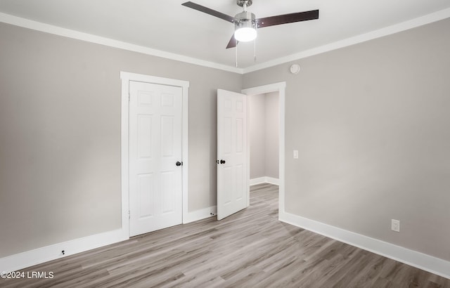 unfurnished bedroom featuring crown molding, ceiling fan, and light wood-type flooring