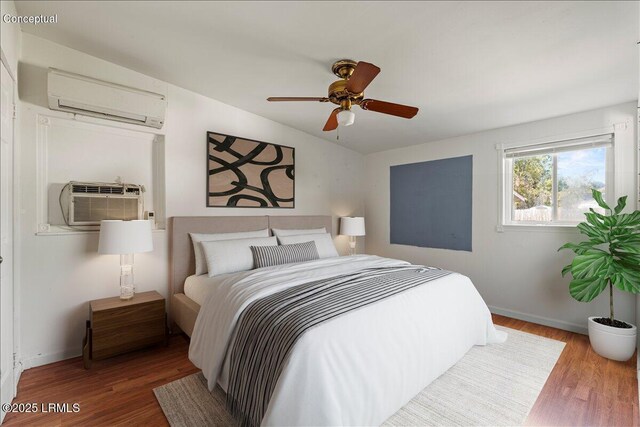 unfurnished room featuring ceiling fan, a wall mounted AC, and hardwood / wood-style floors