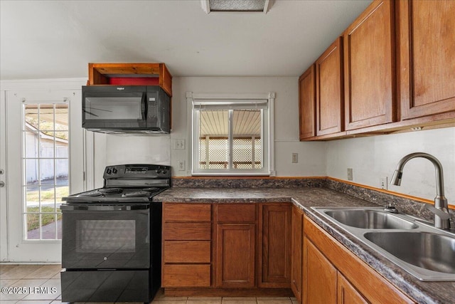 kitchen featuring light tile patterned floors, sink, and black appliances