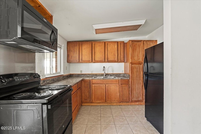 kitchen featuring sink, light tile patterned floors, and black appliances