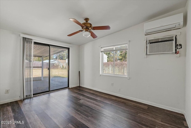 spare room with dark hardwood / wood-style floors, a wall mounted AC, and ceiling fan