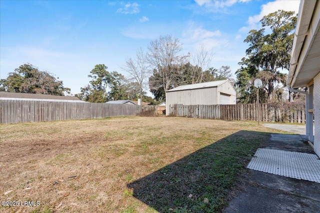 view of yard with a garage and an outbuilding