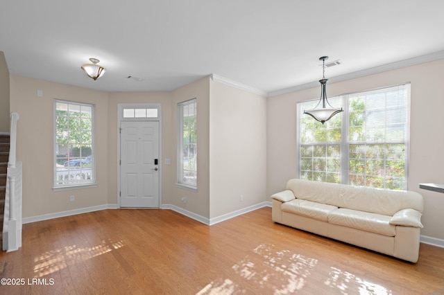 16 Maidencane St, Bluffton, SC 29910 - entrance foyer featuring wood finished floors, baseboards, crown molding, and stairway