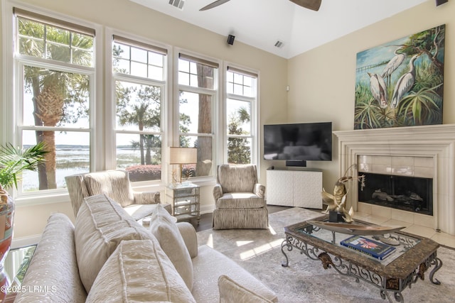 71 Peninsula Dr, Hilton Head Island, SC 29926 - living room with a ceiling fan, a water view, lofted ceiling, and a tile fireplace
