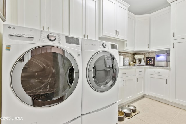 71 Peninsula Dr, Hilton Head Island, SC 29926 - laundry room featuring independent washer and dryer, cabinet space, and light tile patterned floors