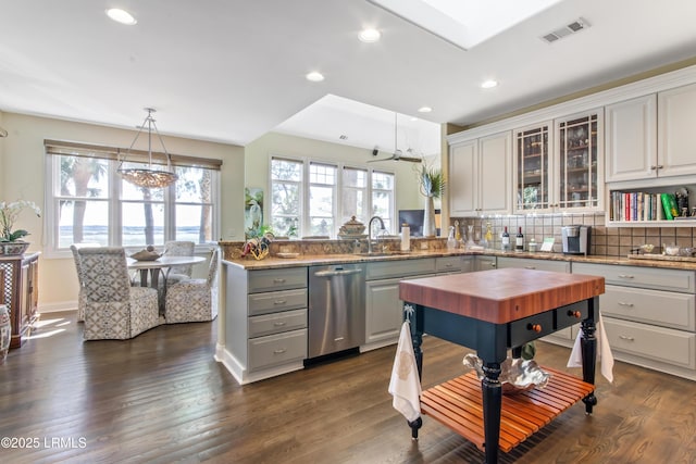 71 Peninsula Dr, Hilton Head Island, SC 29926 - kitchen featuring stainless steel dishwasher, butcher block countertops, a peninsula, decorative light fixtures, and tasteful backsplash
