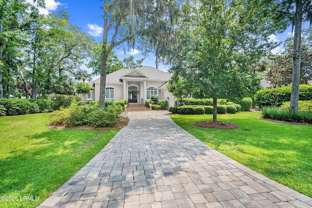 71 Peninsula Dr, Hilton Head Island, SC 29926 - neoclassical / greek revival house featuring a front yard, decorative driveway, and stucco siding