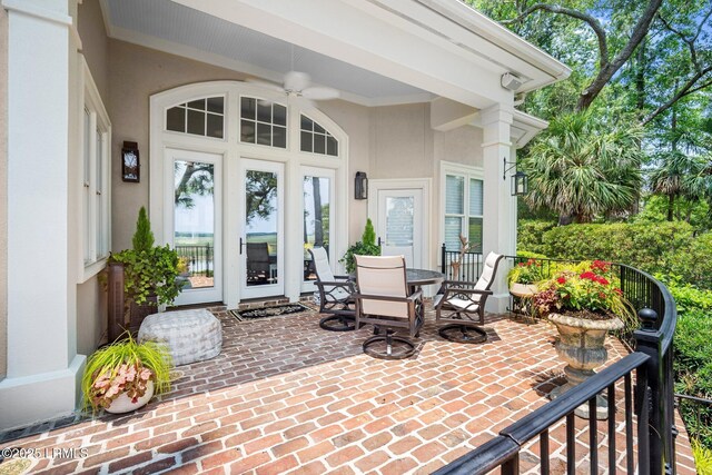 71 Peninsula Dr, Hilton Head Island, SC 29926 - doorway to property featuring stucco siding, outdoor dining space, and a patio
