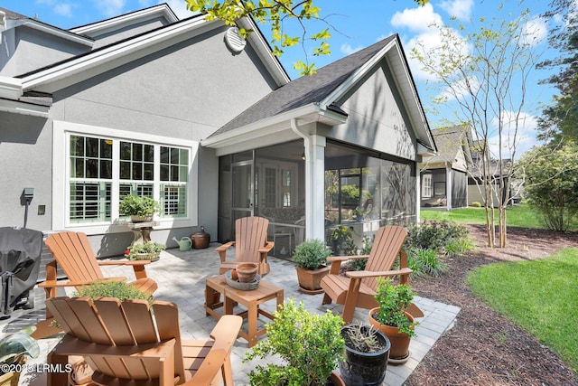 33 Paxton Cir, Bluffton, SC 29910 - exterior space featuring a shingled roof, a fire pit, a sunroom, a patio area, and stucco siding