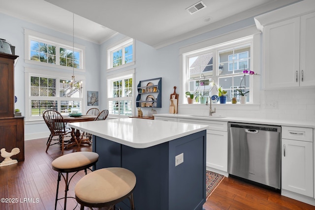 33 Paxton Cir, Bluffton, SC 29910 - kitchen with crown molding, visible vents, a kitchen bar, stainless steel dishwasher, and a sink