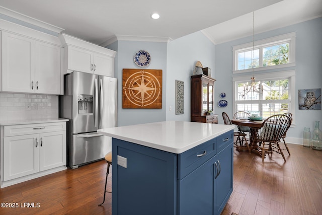 33 Paxton Cir, Bluffton, SC 29910 - kitchen with stainless steel fridge, a chandelier, crown molding, white cabinetry, and blue cabinetry