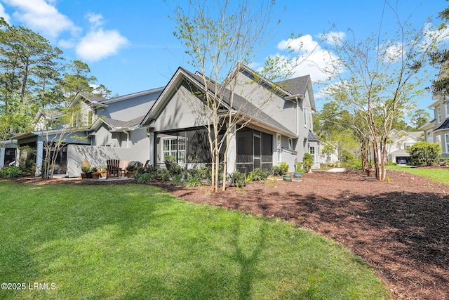 33 Paxton Cir, Bluffton, SC 29910 - back of property with a yard, a sunroom, and stucco siding