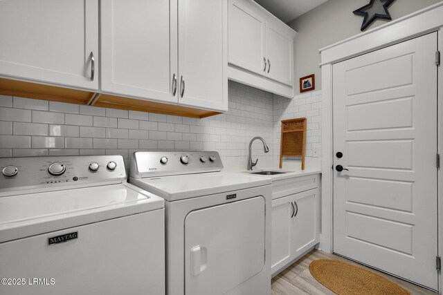 33 Paxton Cir, Bluffton, SC 29910 - washroom featuring cabinet space, washing machine and dryer, light wood-style floors, and a sink