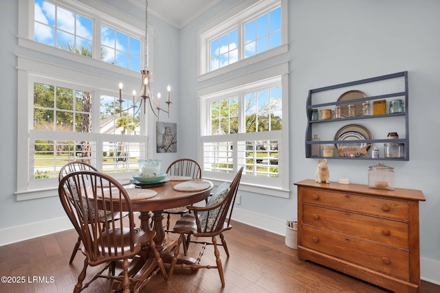 33 Paxton Cir, Bluffton, SC 29910 - dining room with dark wood-style flooring, ornamental molding, a wealth of natural light, and an inviting chandelier