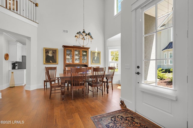 33 Paxton Cir, Bluffton, SC 29910 - dining area with visible vents, baseboards, a notable chandelier, a towering ceiling, and hardwood / wood-style floors
