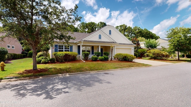 greek revival inspired property featuring a garage and a front lawn