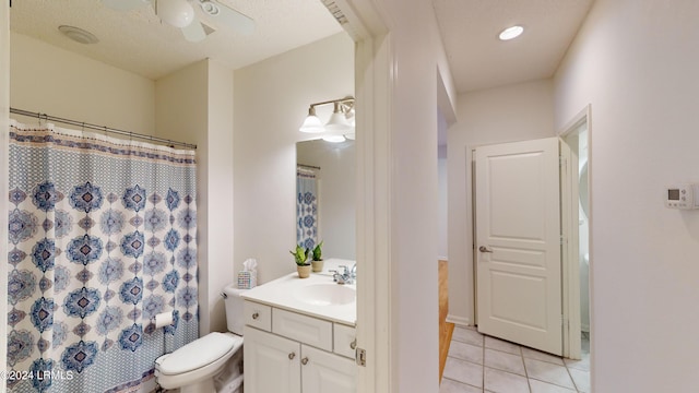 bathroom with curtained shower, tile patterned flooring, vanity, toilet, and a textured ceiling