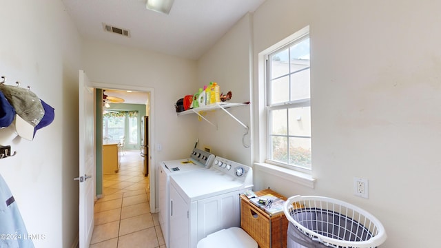 laundry room featuring light tile patterned floors, a wealth of natural light, and independent washer and dryer