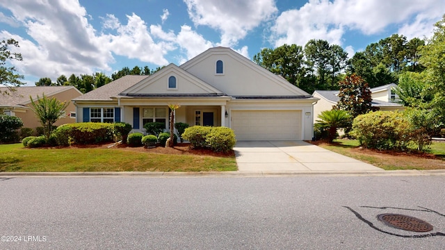 view of front of home featuring a garage and a front yard