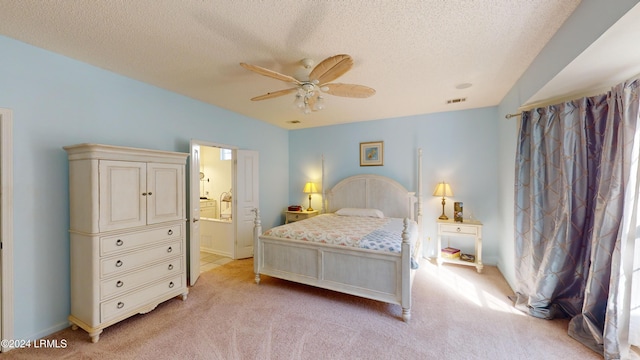 carpeted bedroom featuring a textured ceiling, ceiling fan, and ensuite bathroom