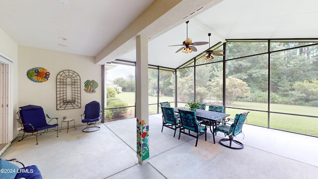 sunroom with ceiling fan, lofted ceiling with beams, and a wealth of natural light