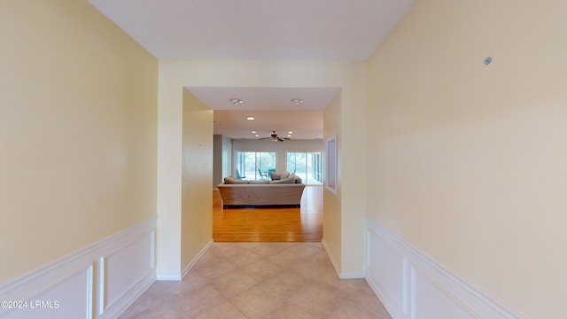 hall featuring light tile patterned flooring