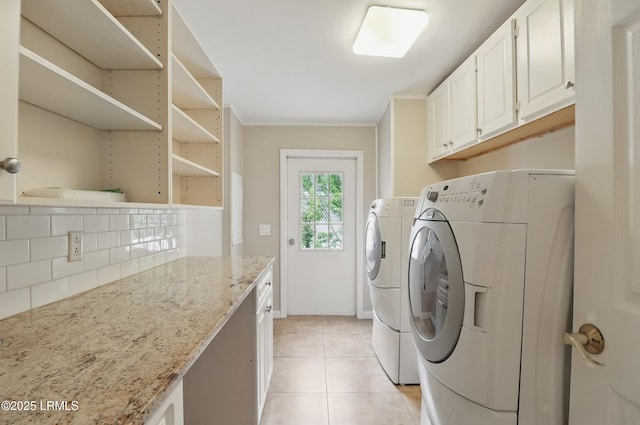 41 Able St, Bluffton, SC 29910 - clothes washing area featuring washer and dryer, cabinet space, and light tile patterned floors