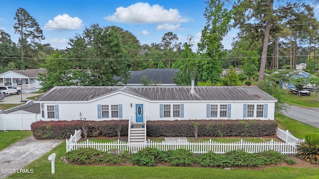 41 Able St, Bluffton, SC 29910 - view of front of home featuring metal roof and a fenced front yard