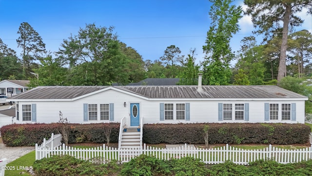 41 Able St, Bluffton, SC 29910 - view of front of property with metal roof and a fenced front yard